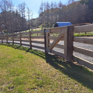 four rail post and rail fence around a paddock near Rotorua