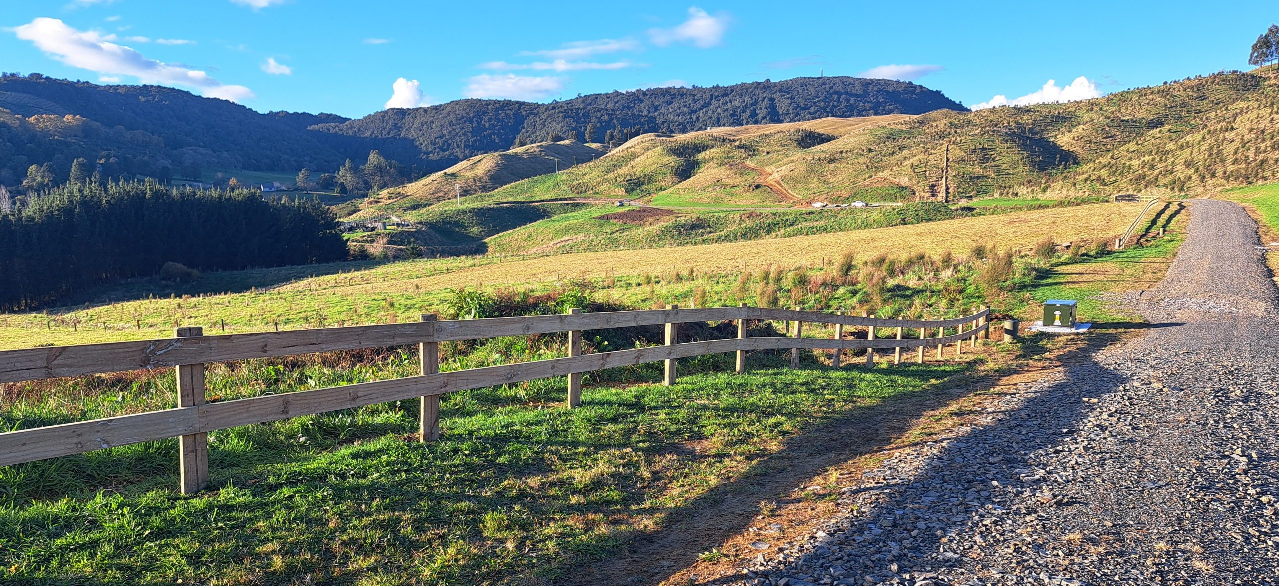 Rail fence along scenic road in subdivided rural land in Rotorua
